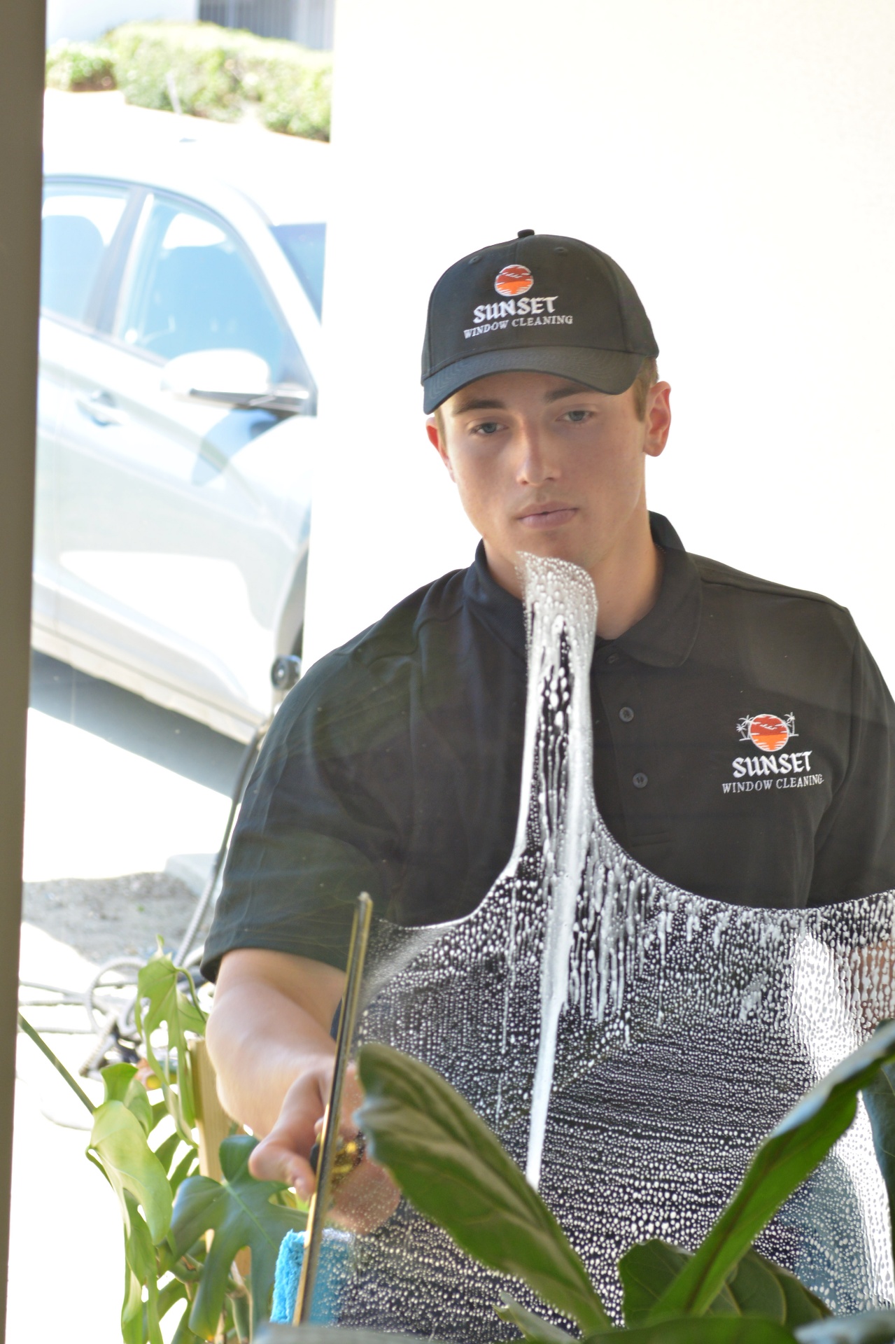 Ryan cleaning a window with a squeegee